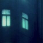 a 3d layered glass trptych artwork portraying a noir urban landscape deep in the heart of the city. Shadowy buildings, glowing streetlights and windows rendered in stacked transluscent layers of glass, creating depth, mystery and cinematic atmosphere