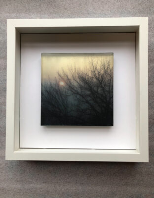 A rare and magical scene set in nature, depicting the rising sun shining through the morning mist and trees set in layers of trasluscent float glass